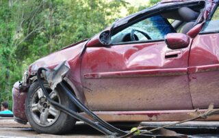 Red sedan that has been in a rollover accident