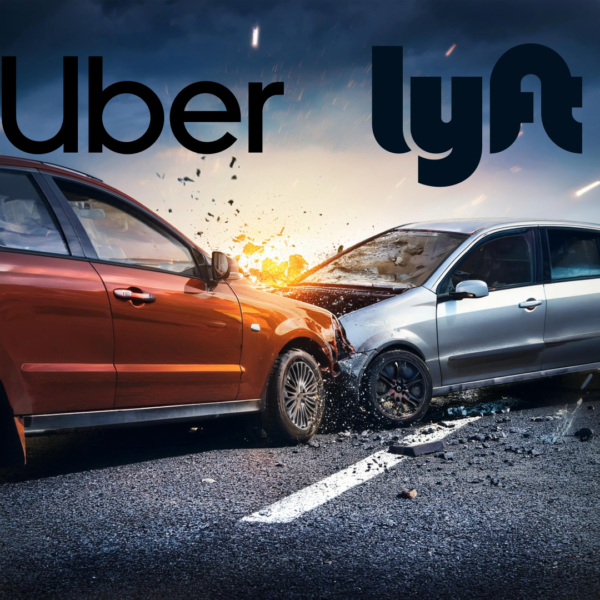 Two cars, one red and one silver, colliding frontally on a road with Uber and Lyft logos above.