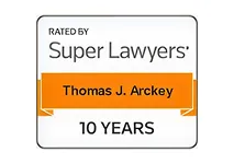Badge with text "Rated by Super Lawyers," featuring the name Thomas J. Arckey and "10 years.