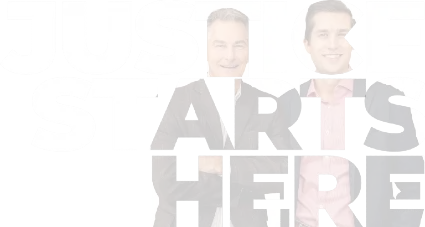 Two professionally dressed men smiling, with large text behind them reading "JUSTICE STARTS HERE.